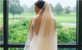 A bride overlooking the grounds from our lobby tiers